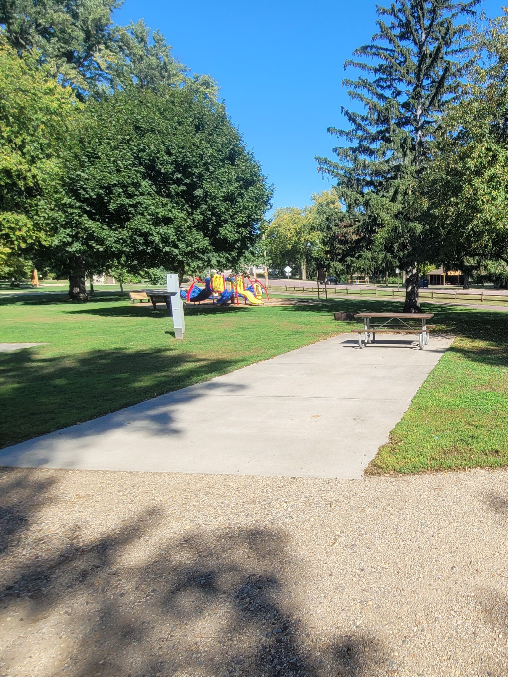 campground site campground site 15 with a gravel path, trees, and green grass