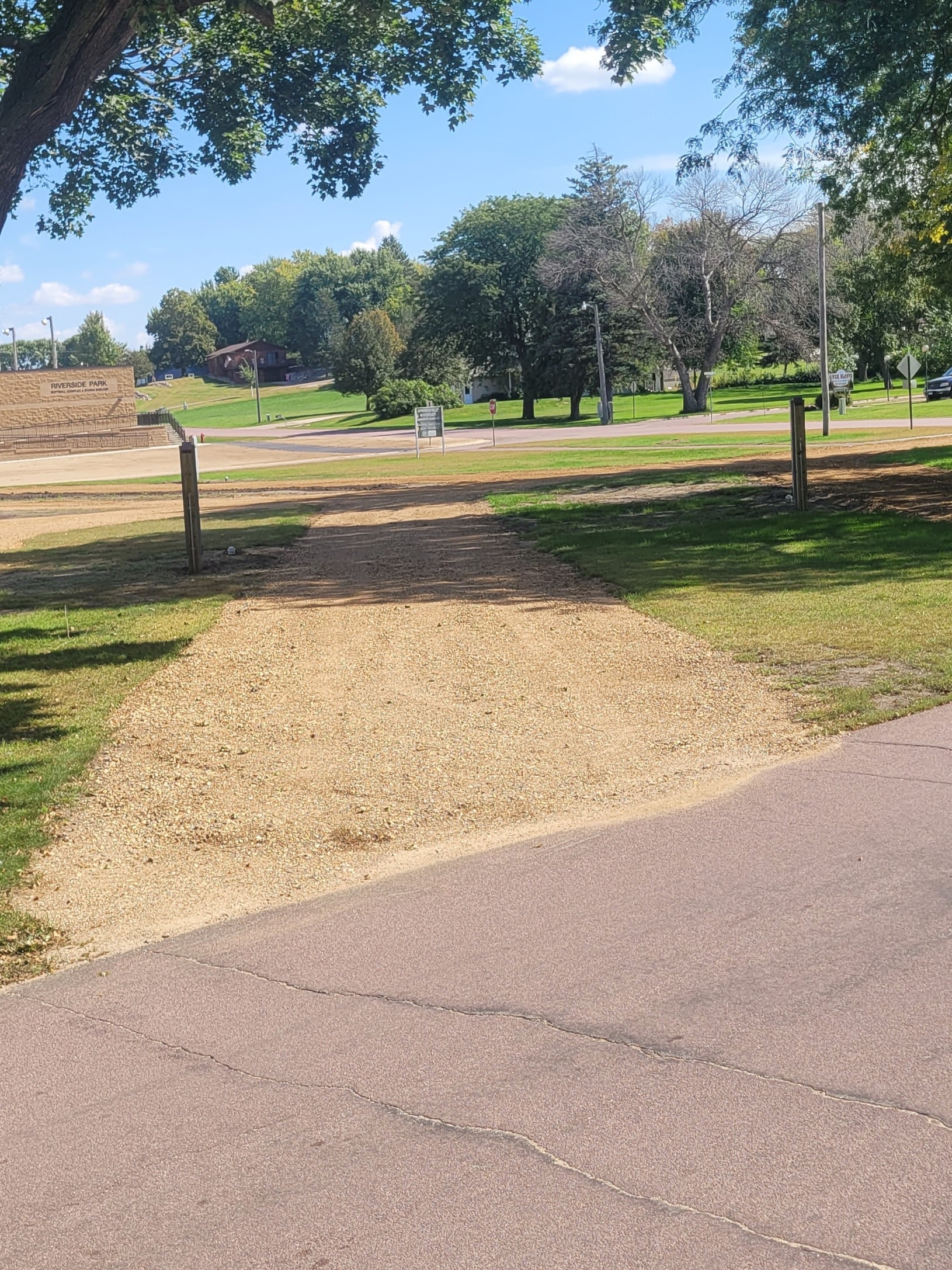 campground site 43 with a gravel path, trees, and green grass