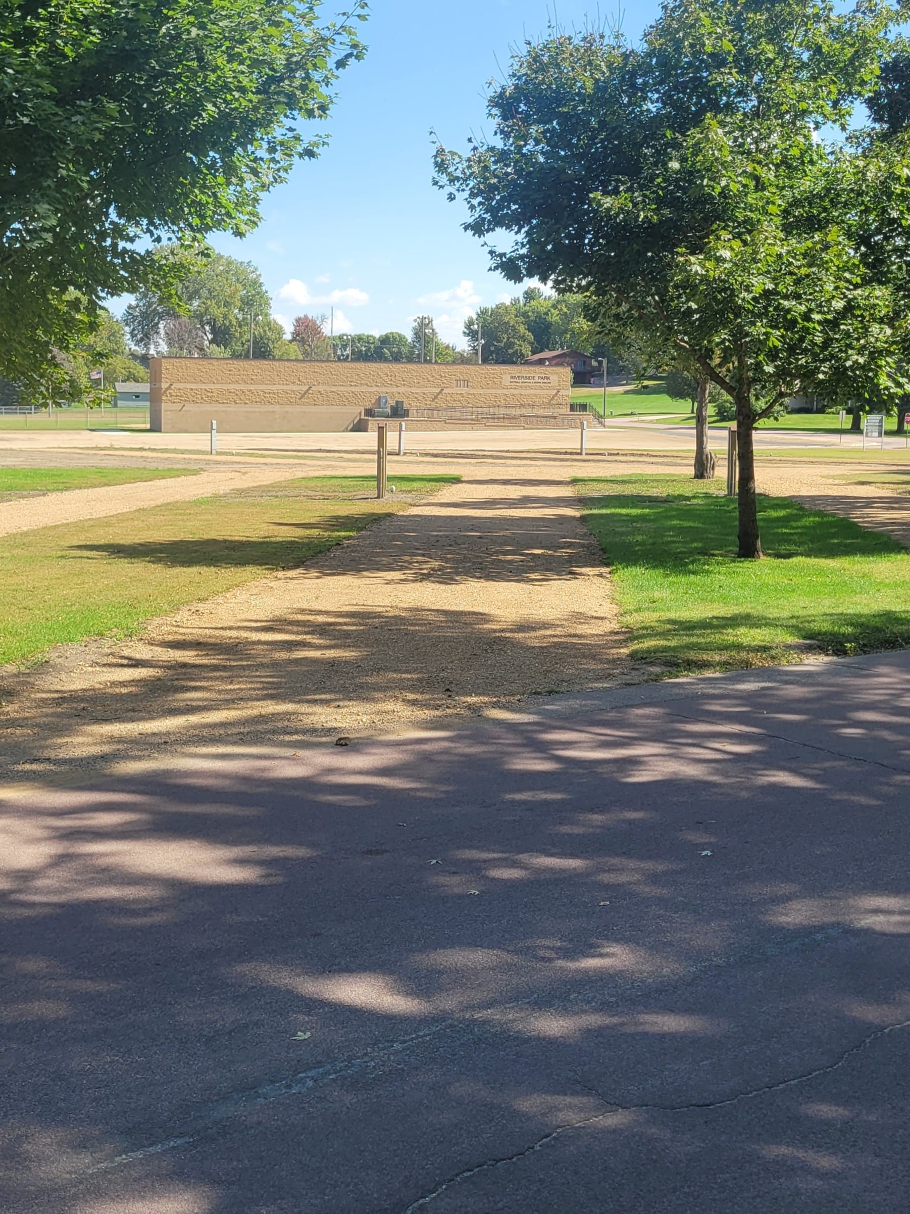 campground site 45 with a gravel path, trees, and green grass