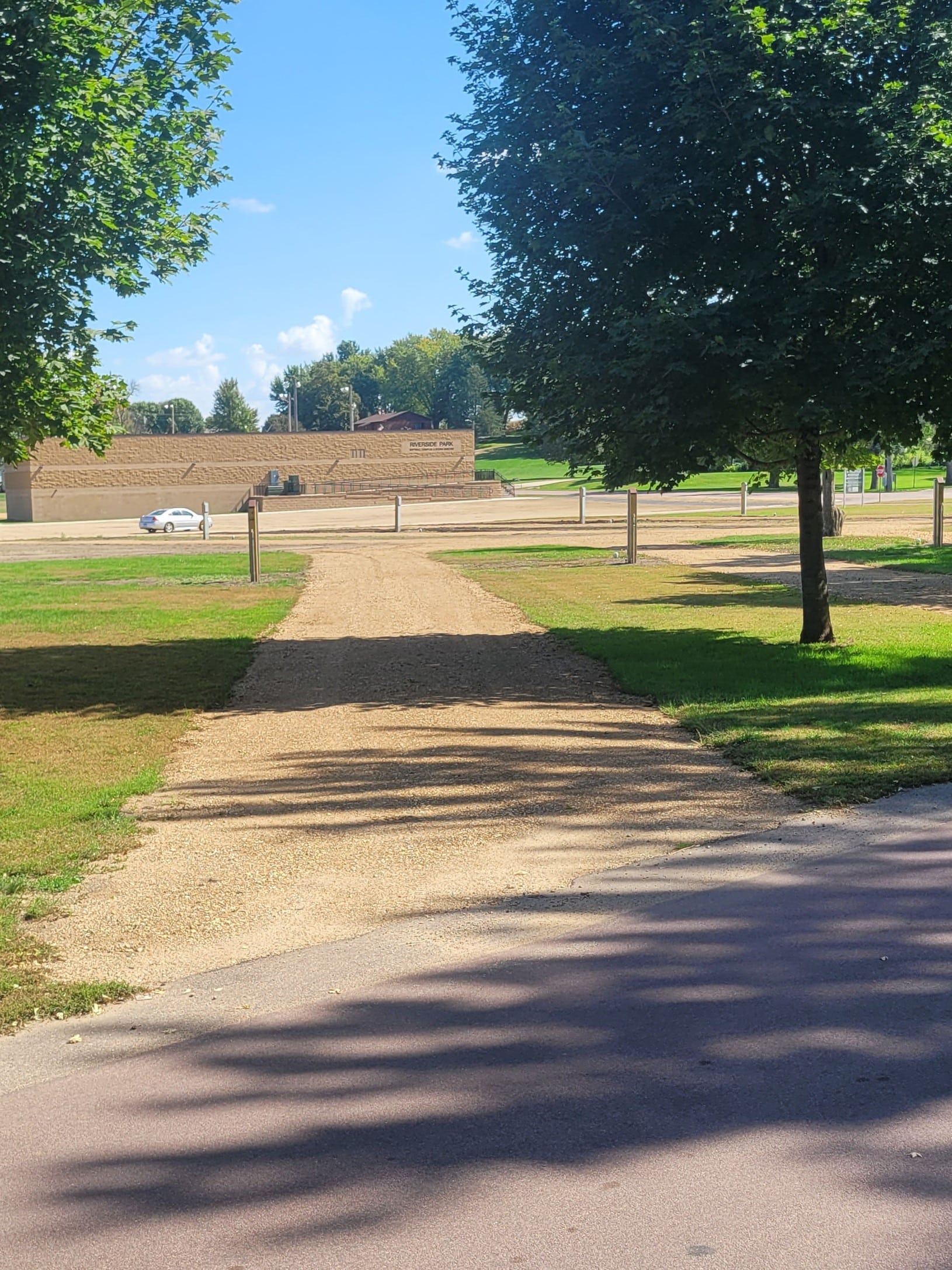 campground site 46 with a gravel path, trees, and green grass