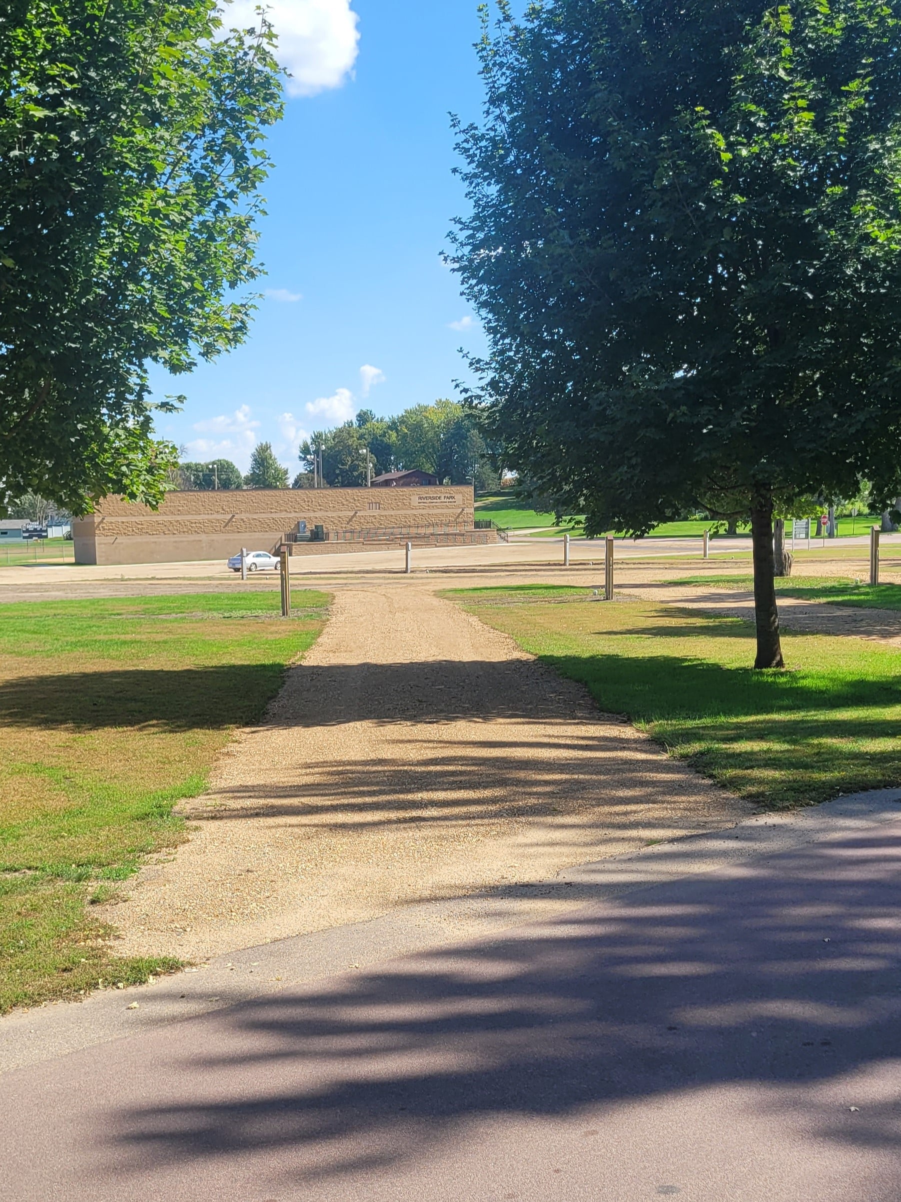 campground site 46 with a gravel path, trees, and green grass