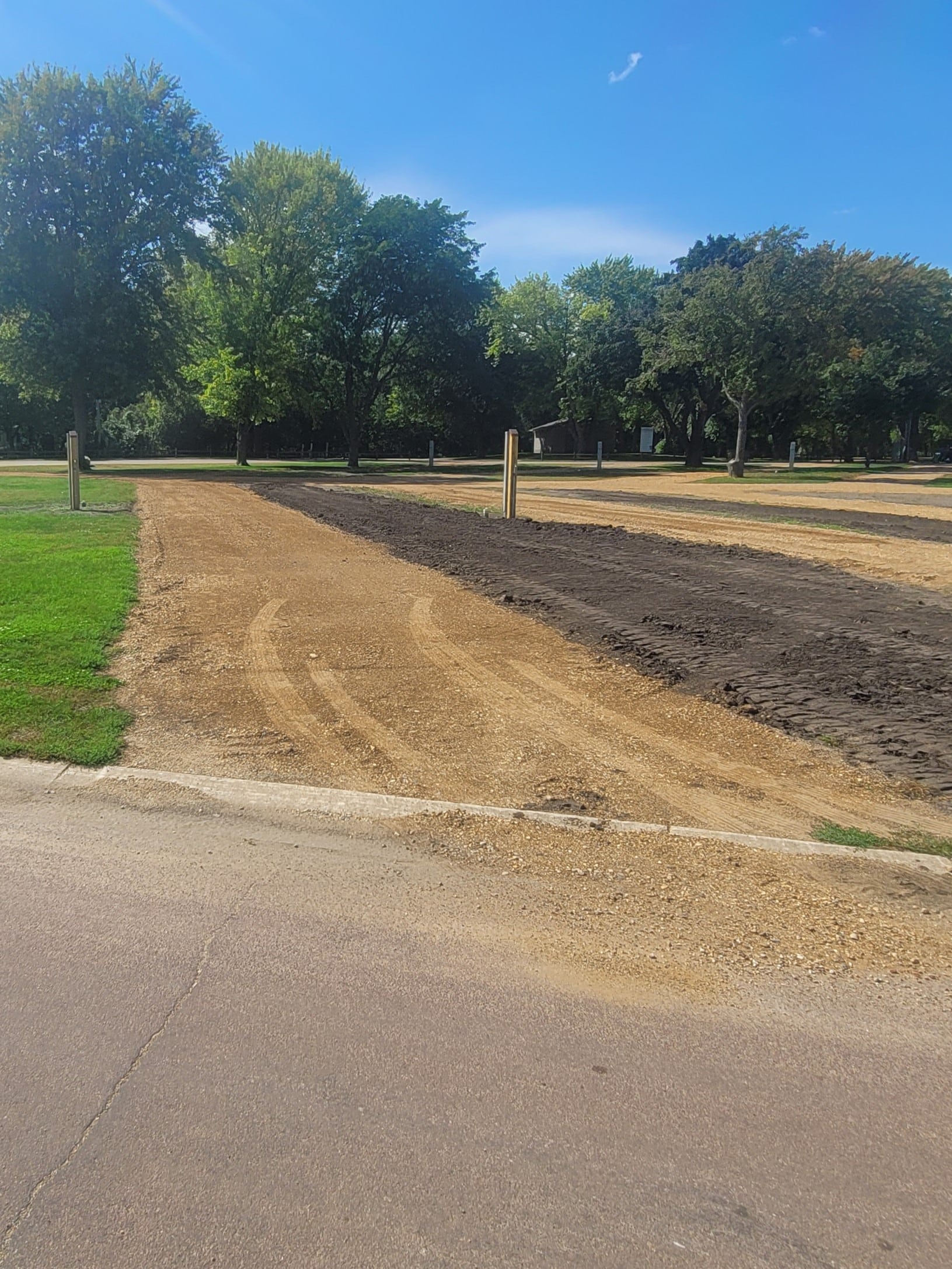 campground site 47 with a gravel path, trees, and green grass