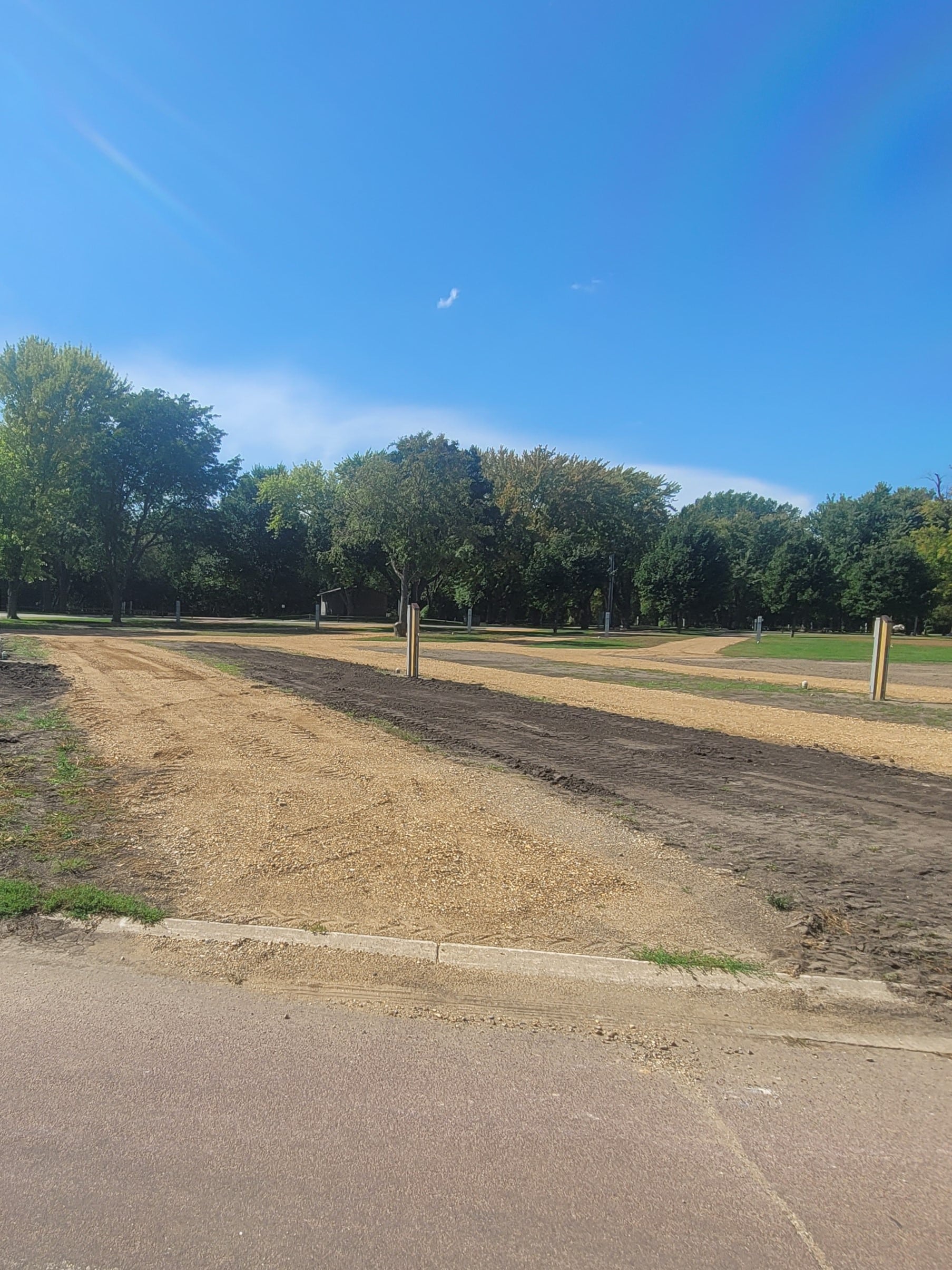 campground site 48 with a gravel path, trees, and green grass