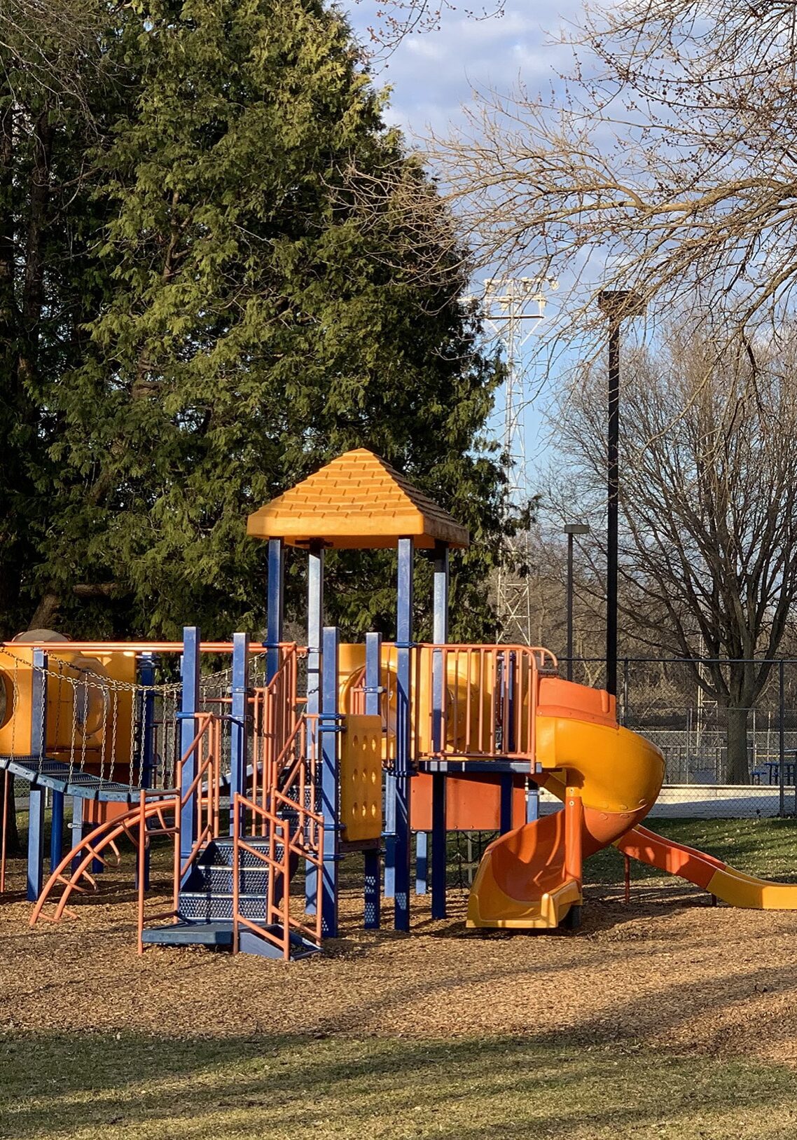 riverside park with 2 climbing frame and a park bench